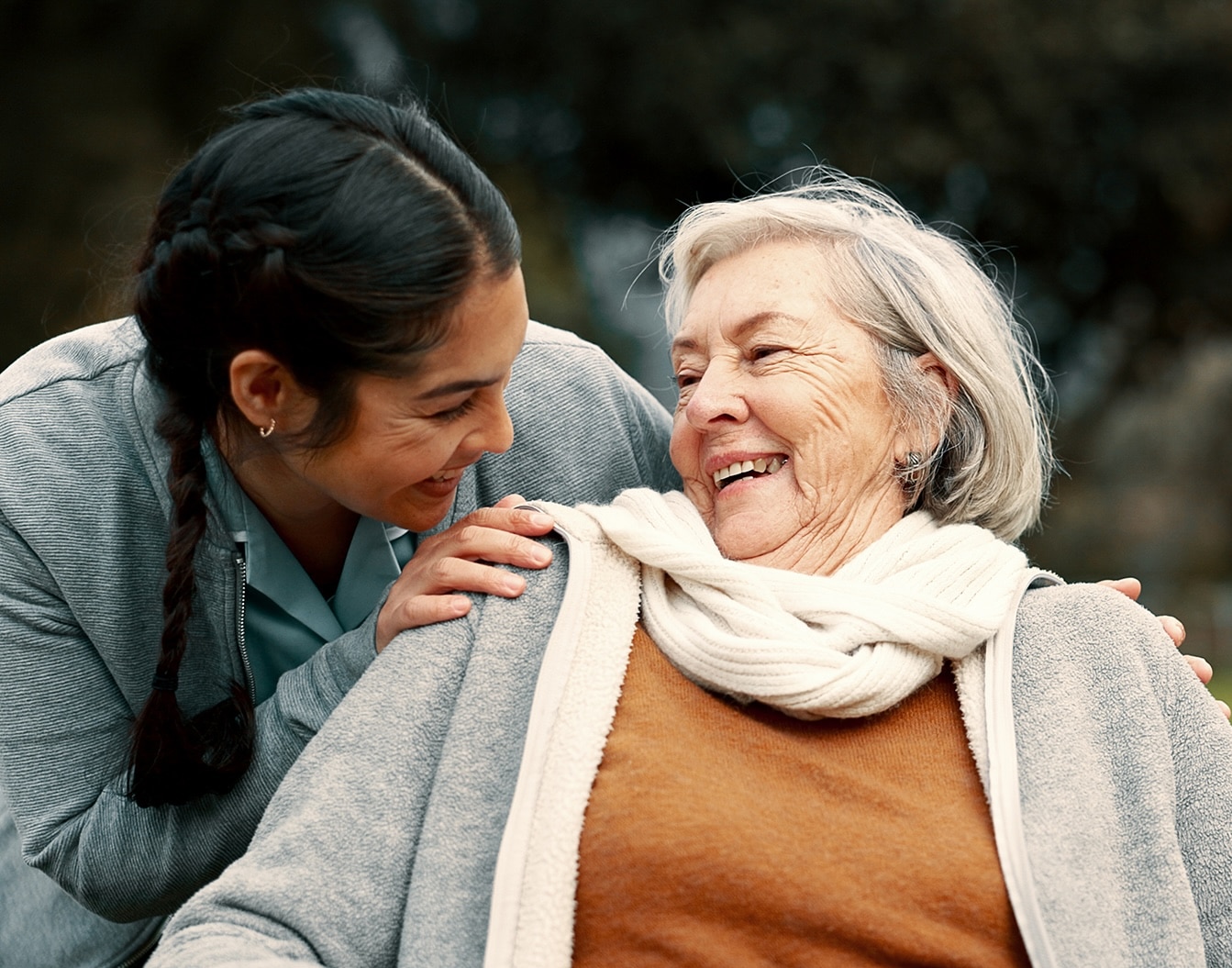 Caregiver helping woman with disability in park for support, trust and care in retirement. Nurse talking to happy senior patient in wheelchair for rehabilitation, therapy and conversation in garden Caregiver helping woman with disability in park for support, trust and care in retirement. Nurse talking to happy senior patient in wheelchair for rehabilitation, therapy and conversation in garden